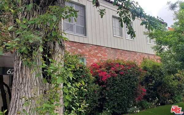 a view of a house with a flower garden