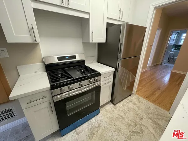 a kitchen with a stove and a refrigerator