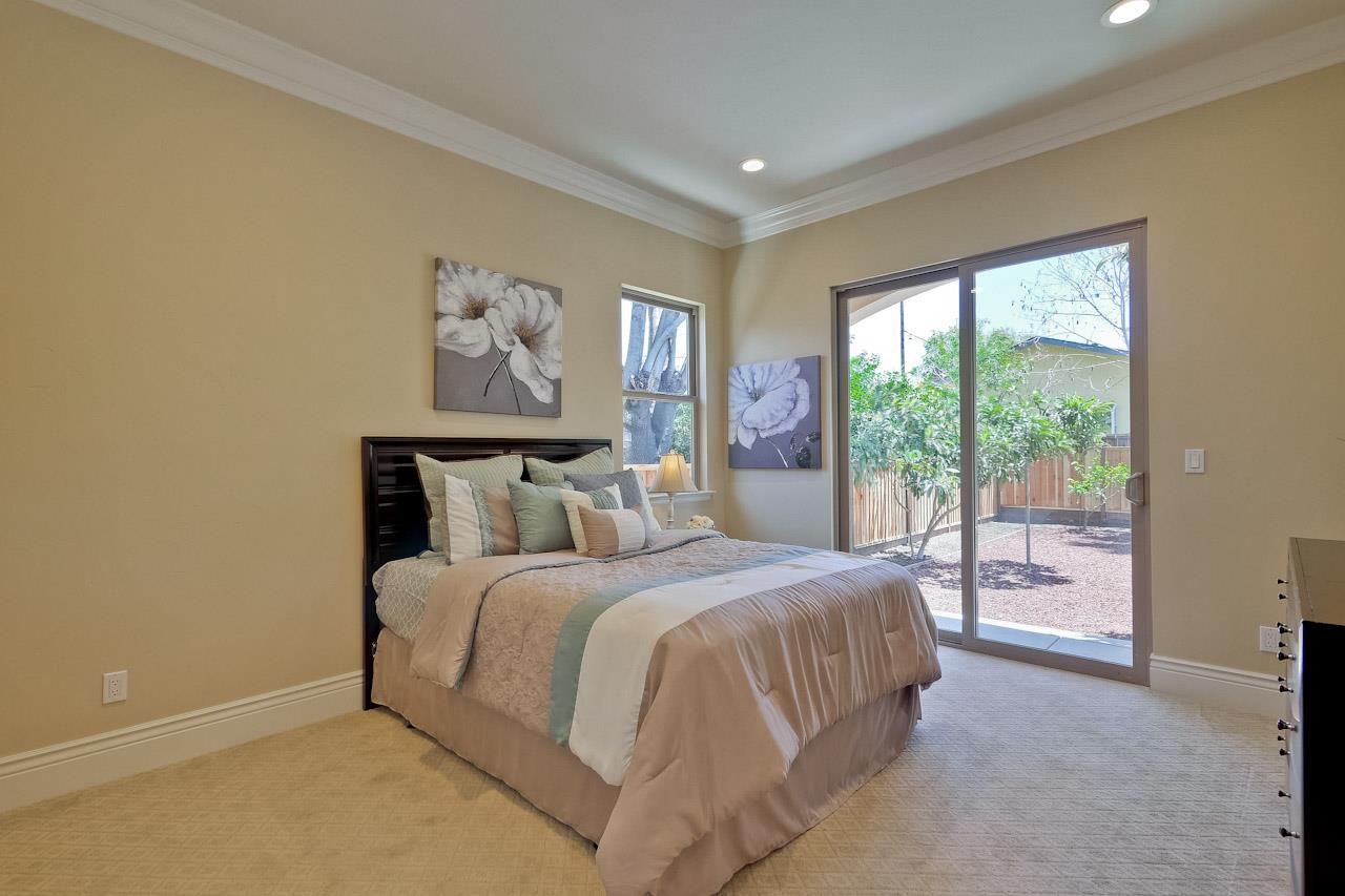 932 Marion Way Sunnyvale, CA 94087 - Photo 24 of 47 a bedroom with a large bed and a painting on the wall