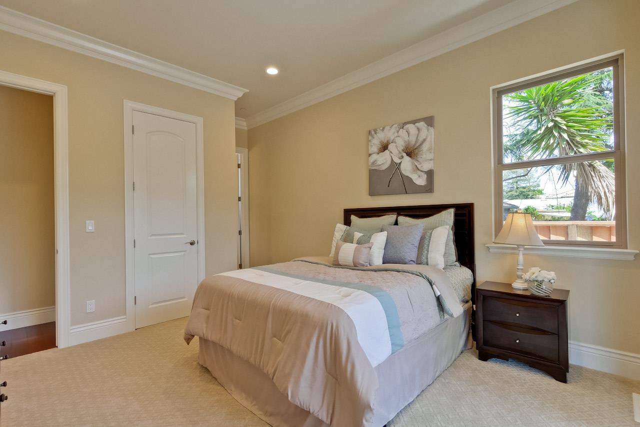 932 Marion Way Sunnyvale, CA 94087 - Photo 26 of 47 a spacious bedroom with a bed and a window