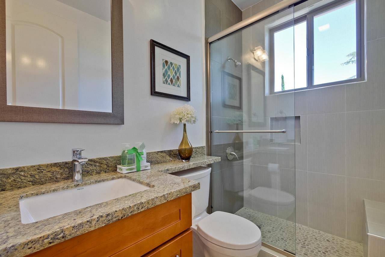 932 Marion Way Sunnyvale, CA 94087 - Photo 31 of 47 a bathroom with a granite countertop sink toilet and shower