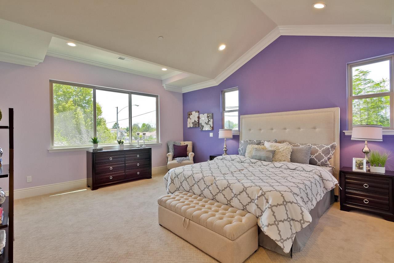 932 Marion Way Sunnyvale, CA 94087 - Photo 36 of 47 a bedroom with a large bed and dresser with mirror
