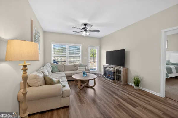 a living room with furniture and a flat screen tv