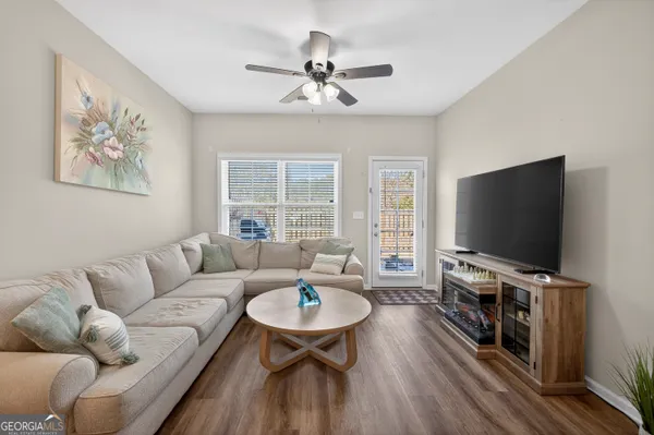 a living room with furniture and a flat screen tv