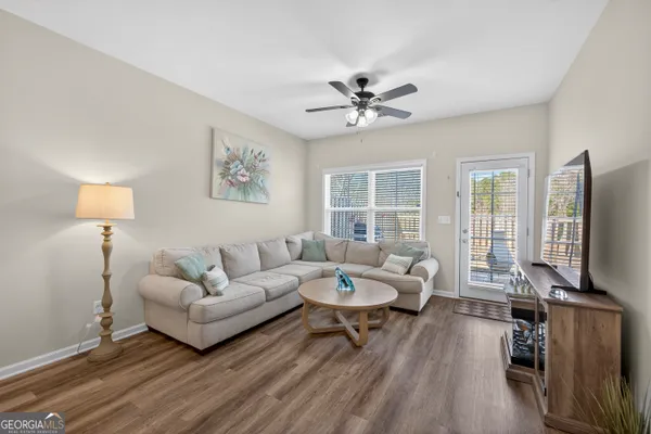a living room with furniture a fireplace and a flat screen tv