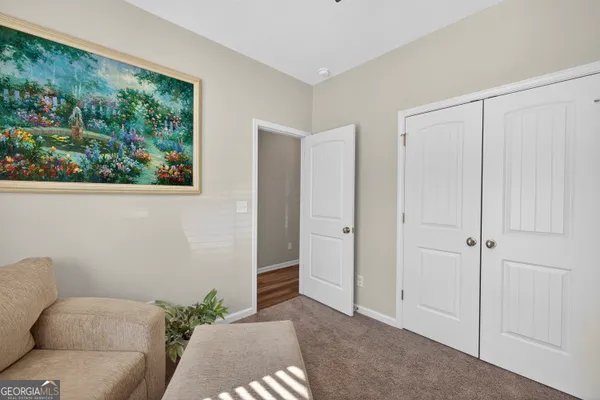 a living room with a couch and a painting on the wall