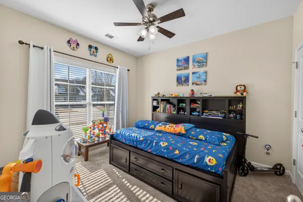 a bed room with furniture and a window