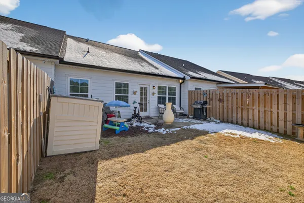 a view of a house with wooden fence