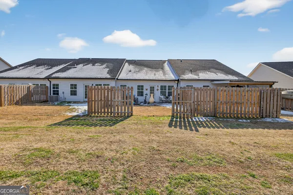 a view of a patio with a table and chairs and floor to ceiling window