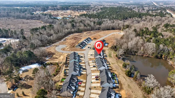 an aerial view of a residential apartment building with a yard