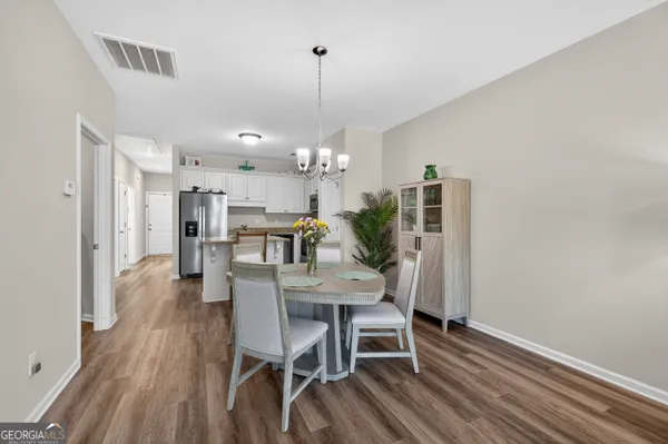 a view of a dining room with furniture and wooden floor