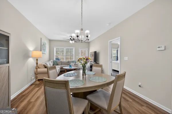 a view of a dining room with furniture and chandelier