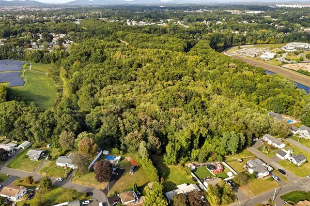 an aerial view of residential houses with outdoor space