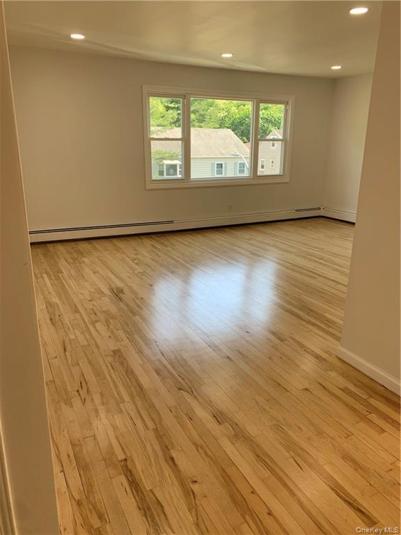 5 Ridge Road, Unit 2 Dobbs Ferry, NY 10522 - Photo 3 of 18 an empty room with wooden floor and windows