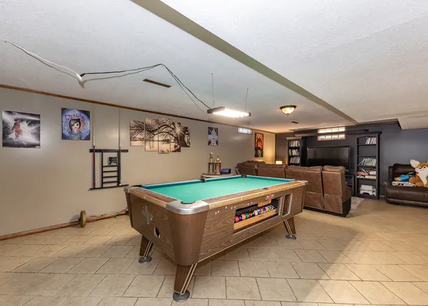 a room with pool table and window