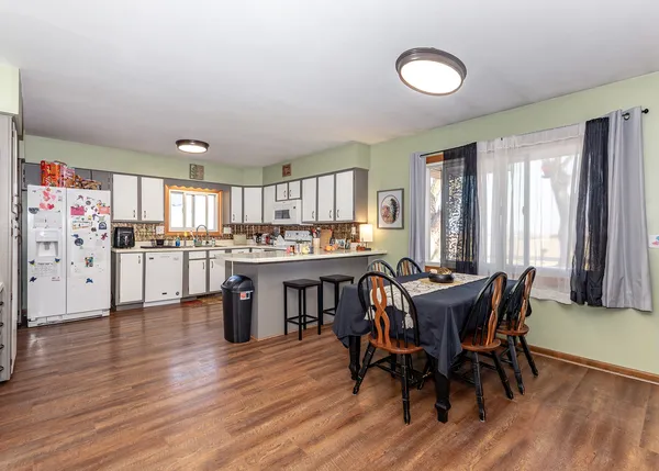 a view of a dining room with furniture and window