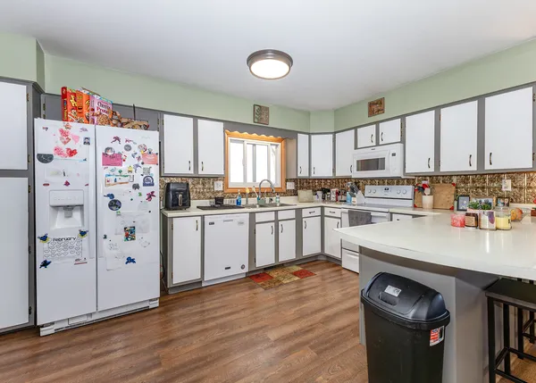 a kitchen with stainless steel appliances white cabinets and a refrigerator