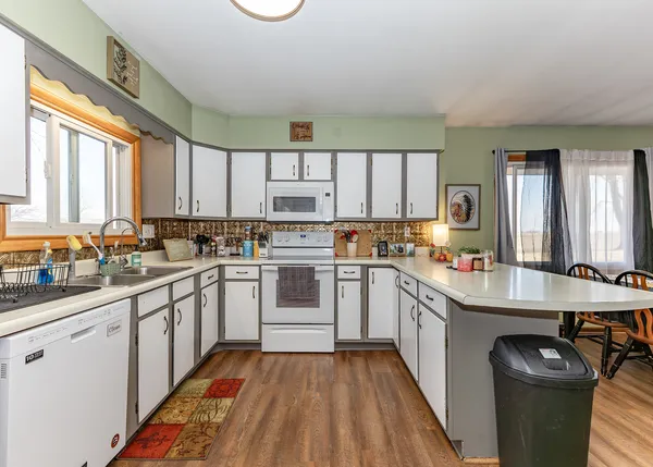 a kitchen with stainless steel appliances granite countertop a stove a sink dishwasher and a refrigerator