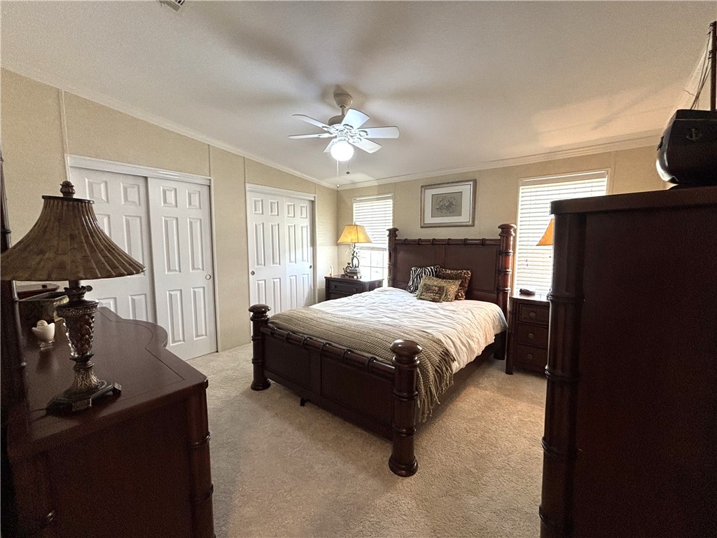 6171 98th Road Sebastian, FL 32958 - Photo 10 of 14 a bedroom with a bed and a chandelier