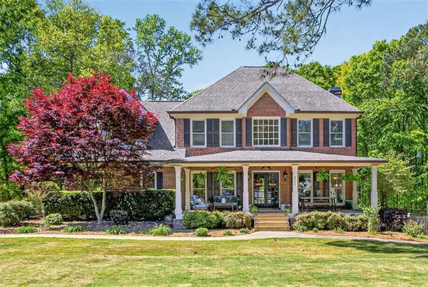 a front view of a house with swimming pool and porch