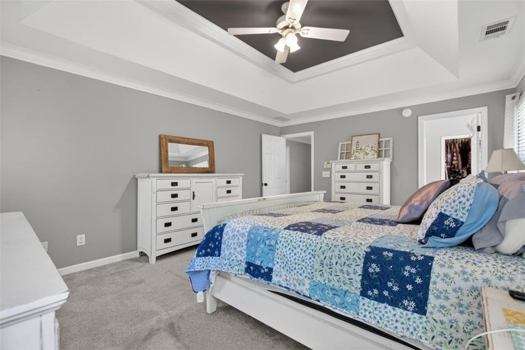 2700 Bay Ridge Drive Loganville, GA 30052 - Photo 29 of 62 a bedroom with a bed and wooden floor