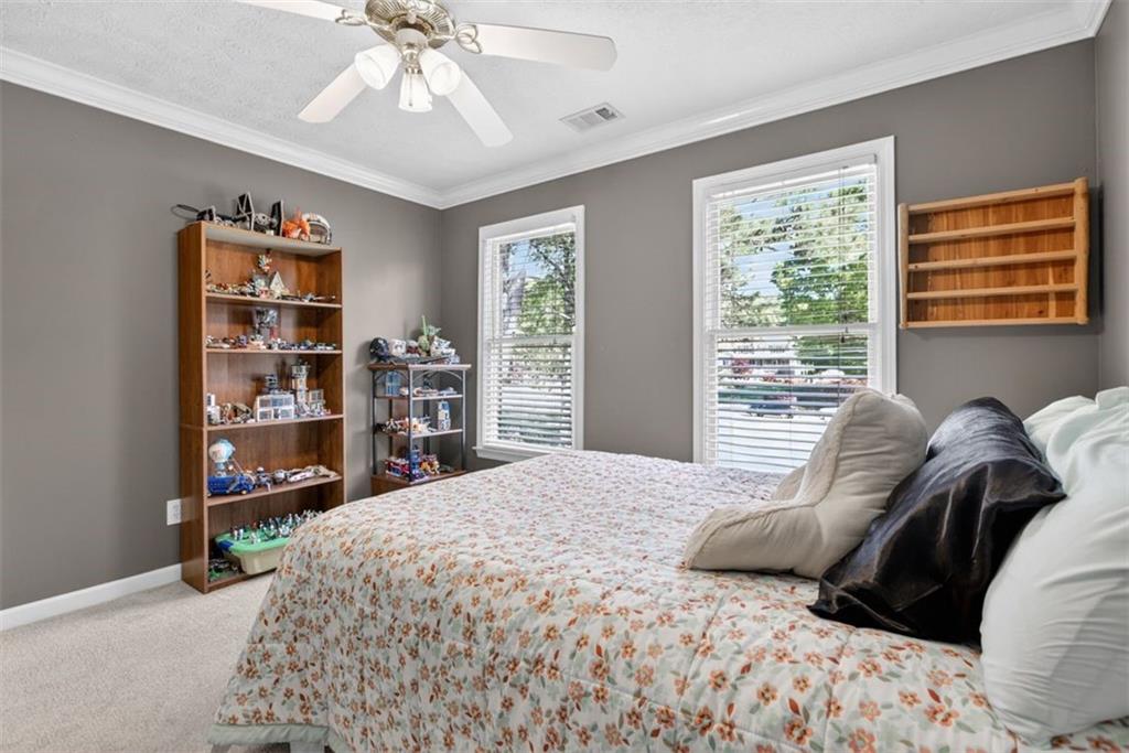 2700 Bay Ridge Drive Loganville, GA 30052 - Photo 39 of 62 a bedroom with a large bed and a window