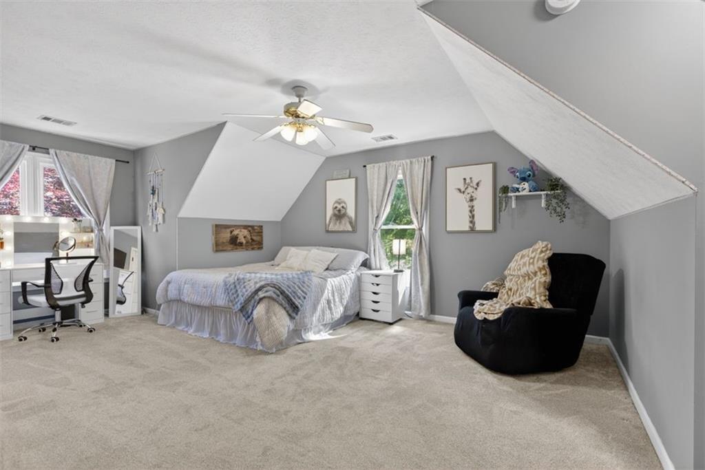 2700 Bay Ridge Drive Loganville, GA 30052 - Photo 41 of 62 a spacious bedroom with a bed a couch and dresser
