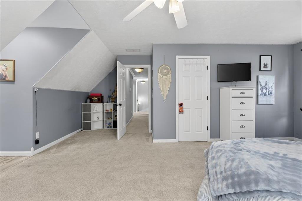 2700 Bay Ridge Drive Loganville, GA 30052 - Photo 43 of 62 a bedroom with a bed and a television in it