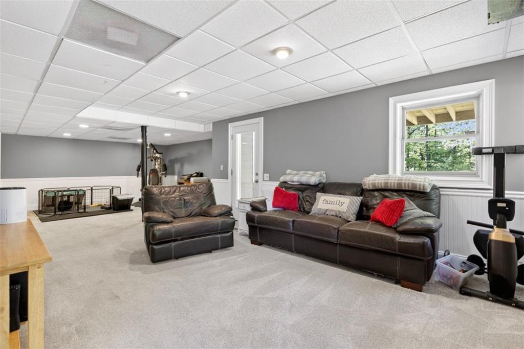 2700 Bay Ridge Drive Loganville, GA 30052 - Photo 46 of 62 a living room with furniture and a flat screen tv