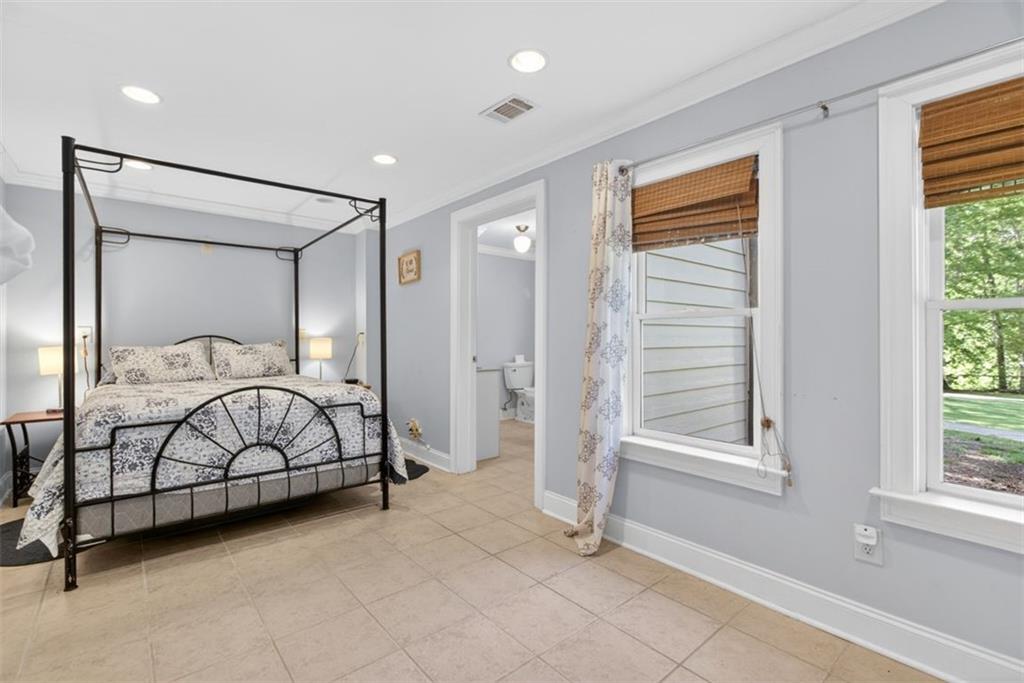 2700 Bay Ridge Drive Loganville, GA 30052 - Photo 53 of 62 a spacious bedroom with a large bed and a window