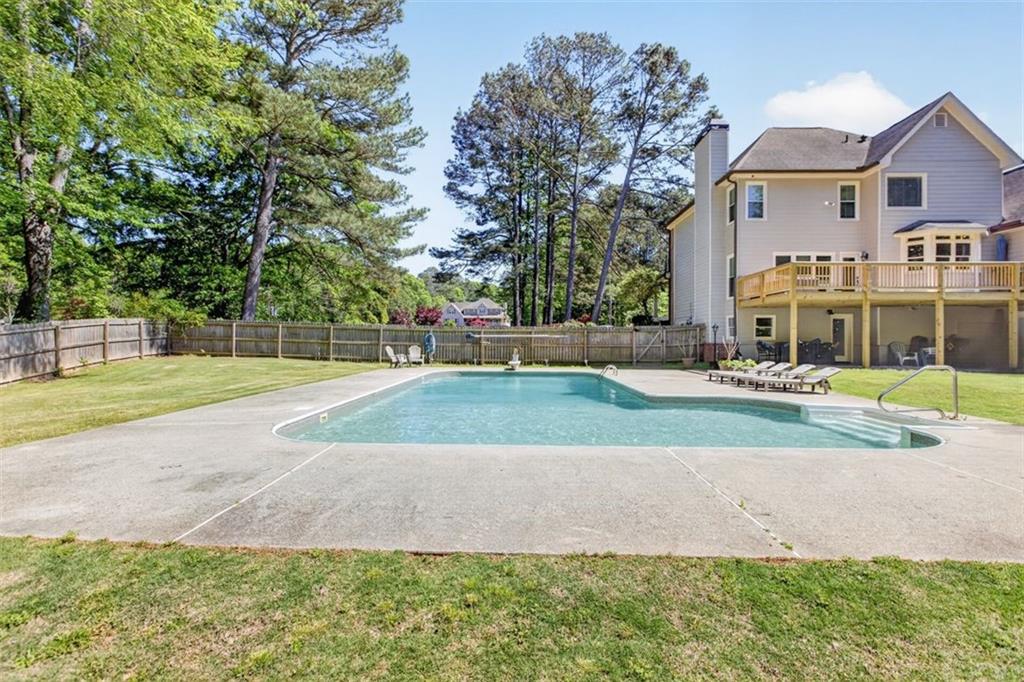 2700 Bay Ridge Drive Loganville, GA 30052 - Photo 60 of 62 a view of a white house with a yard and plants