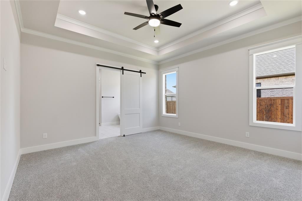 713 Anne Road Van Alstyne, TX 75495 - Photo 9 of 29 Spacious room featuring light gray carpeting, recessed ceiling lighting, a contemporary ceiling fan, and two large windows