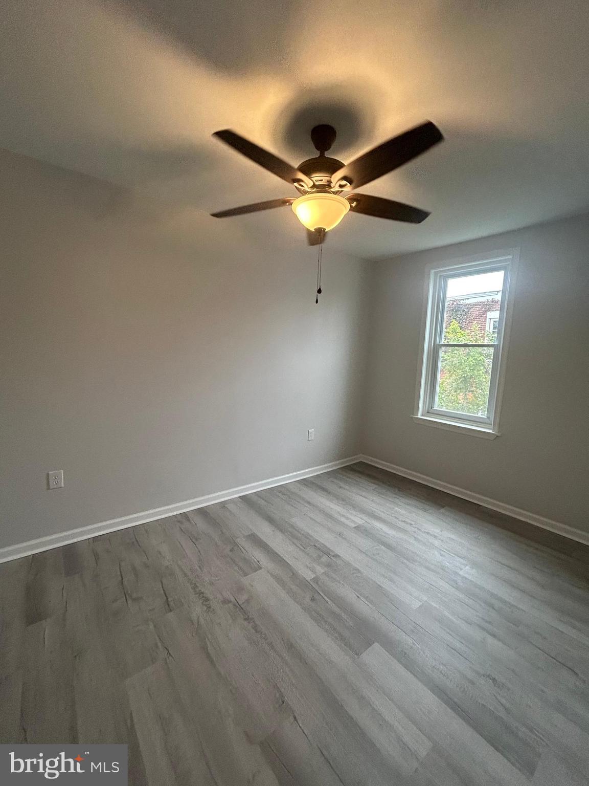 5519 Race Street Philadelphia, PA 19139 - Photo 14 of 25 an empty room with wooden floor fan and windows