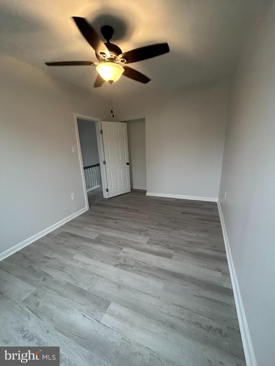 5519 Race Street Philadelphia, PA 19139 - Photo 15 of 25 an empty room with wooden floor fan and windows