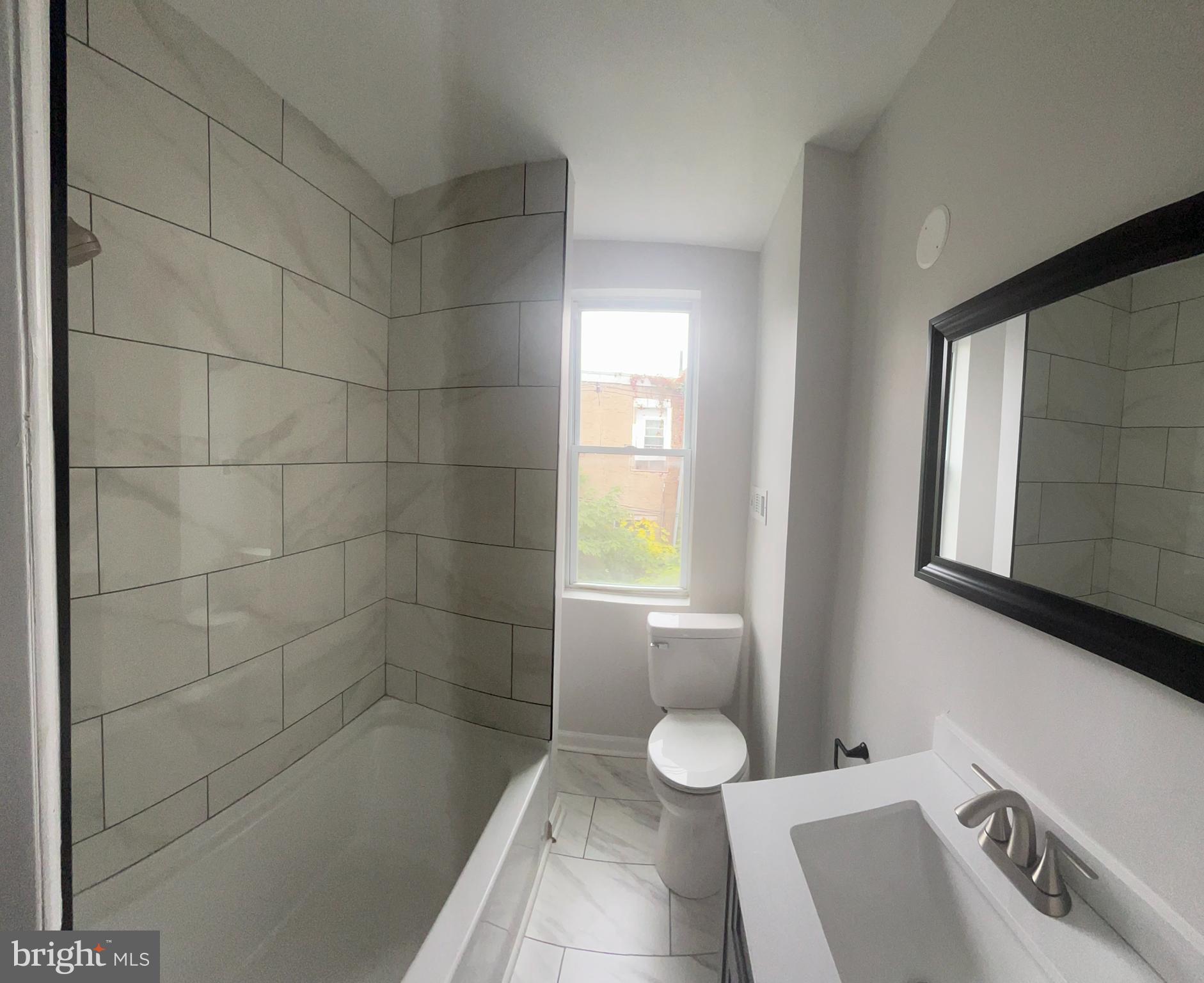 5519 Race Street Philadelphia, PA 19139 - Photo 16 of 25 a bathroom with a sink a toilet and shower