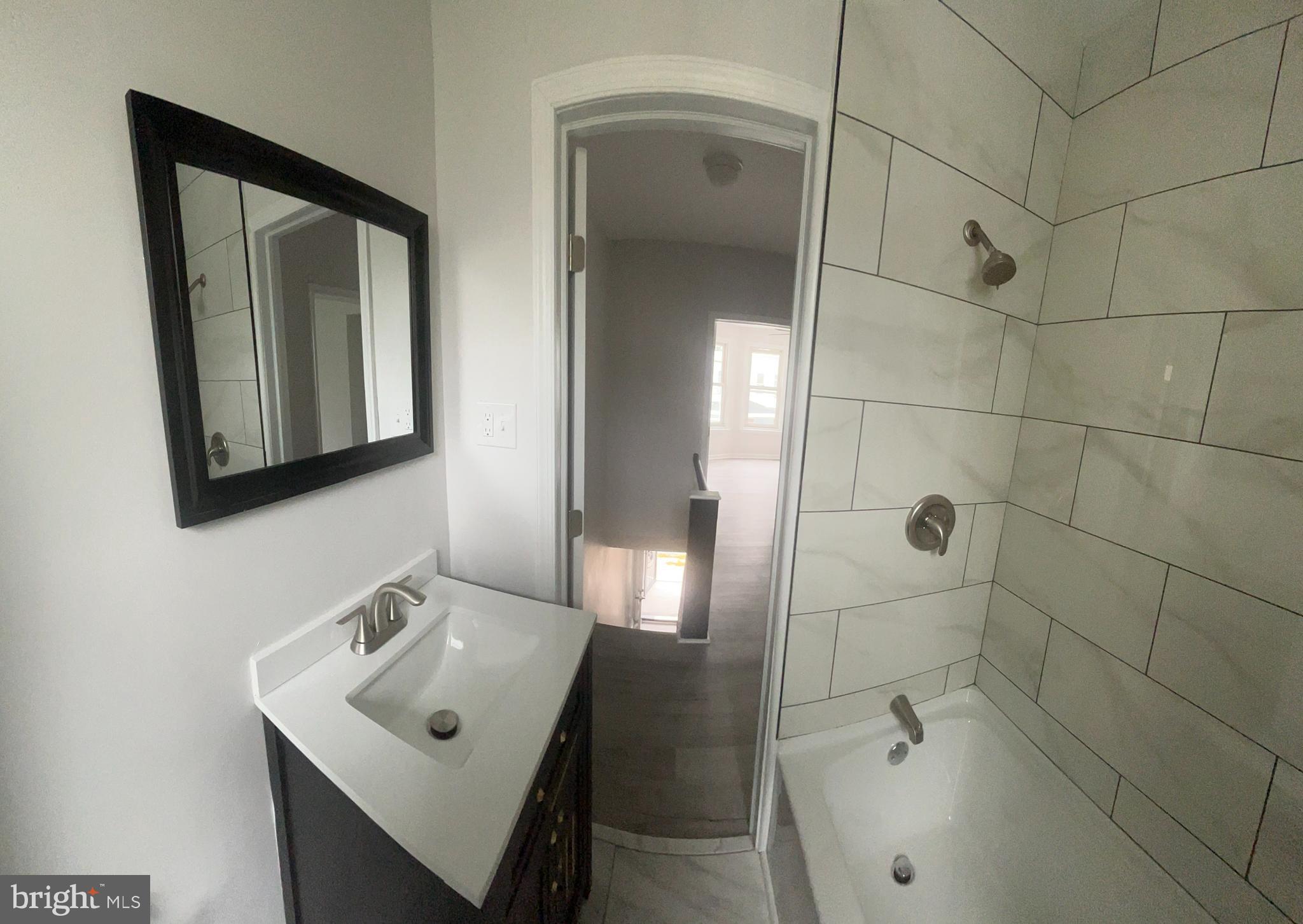 5519 Race Street Philadelphia, PA 19139 - Photo 17 of 25 a bathroom with a sink and mirror