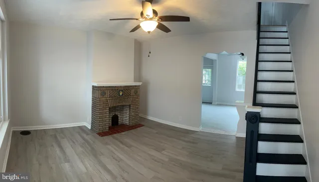 wooden floor in an empty room with a fireplace