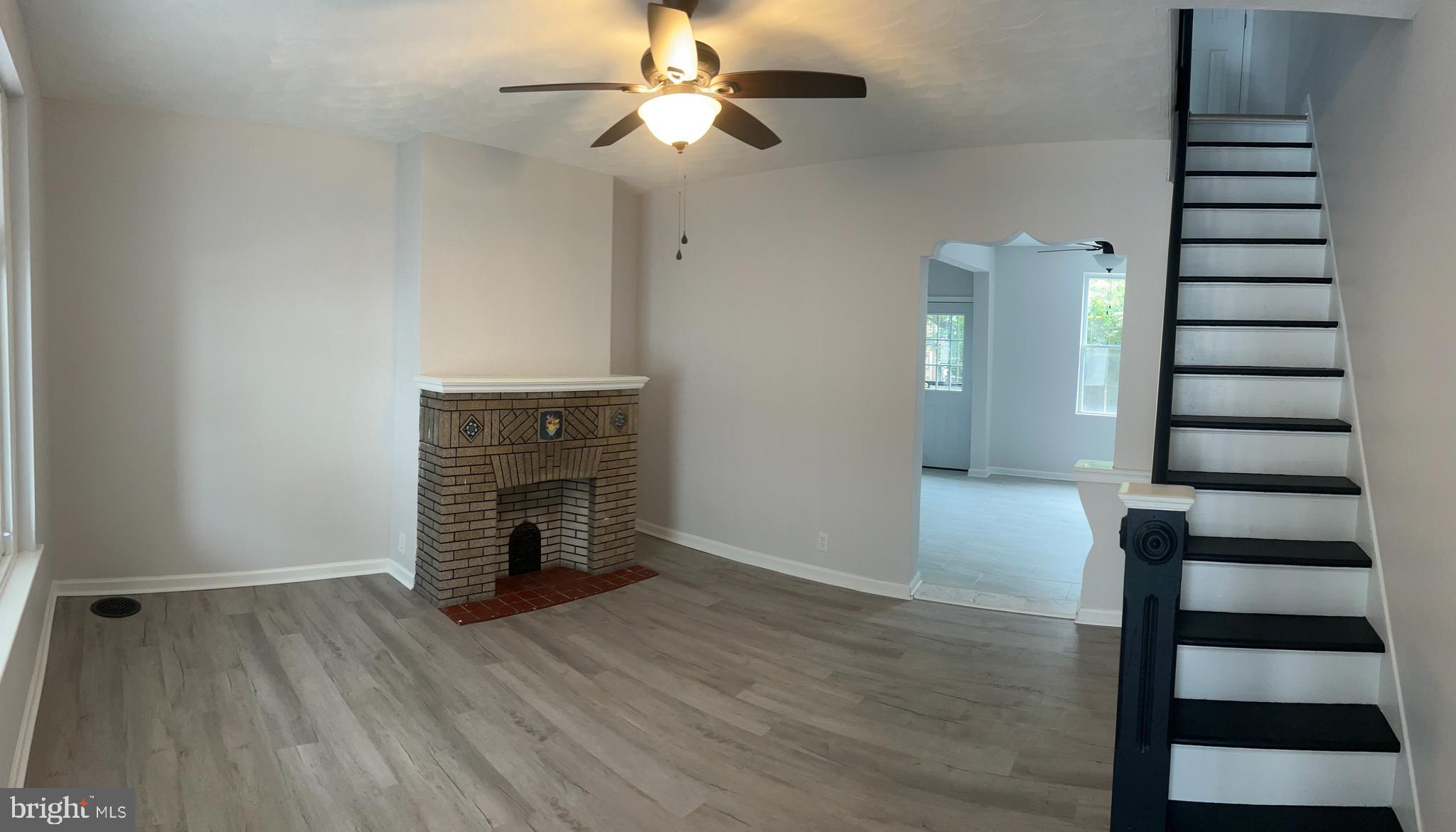 5519 Race Street Philadelphia, PA 19139 - Photo 3 of 25 wooden floor in an empty room with a fireplace