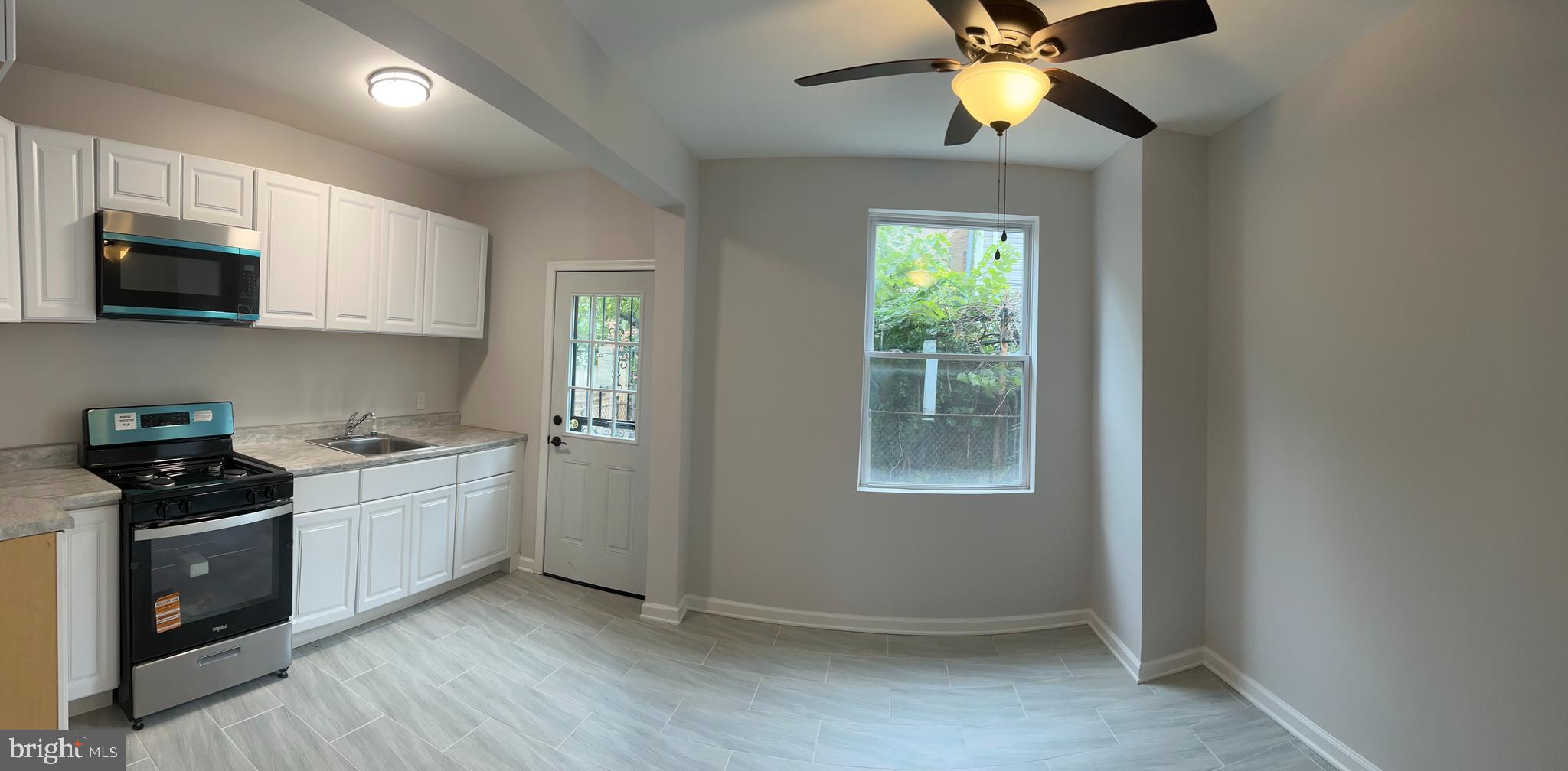 5519 Race Street Philadelphia, PA 19139 - Photo 6 of 25 a kitchen with stainless steel appliances granite countertop a stove a sink and a microwave