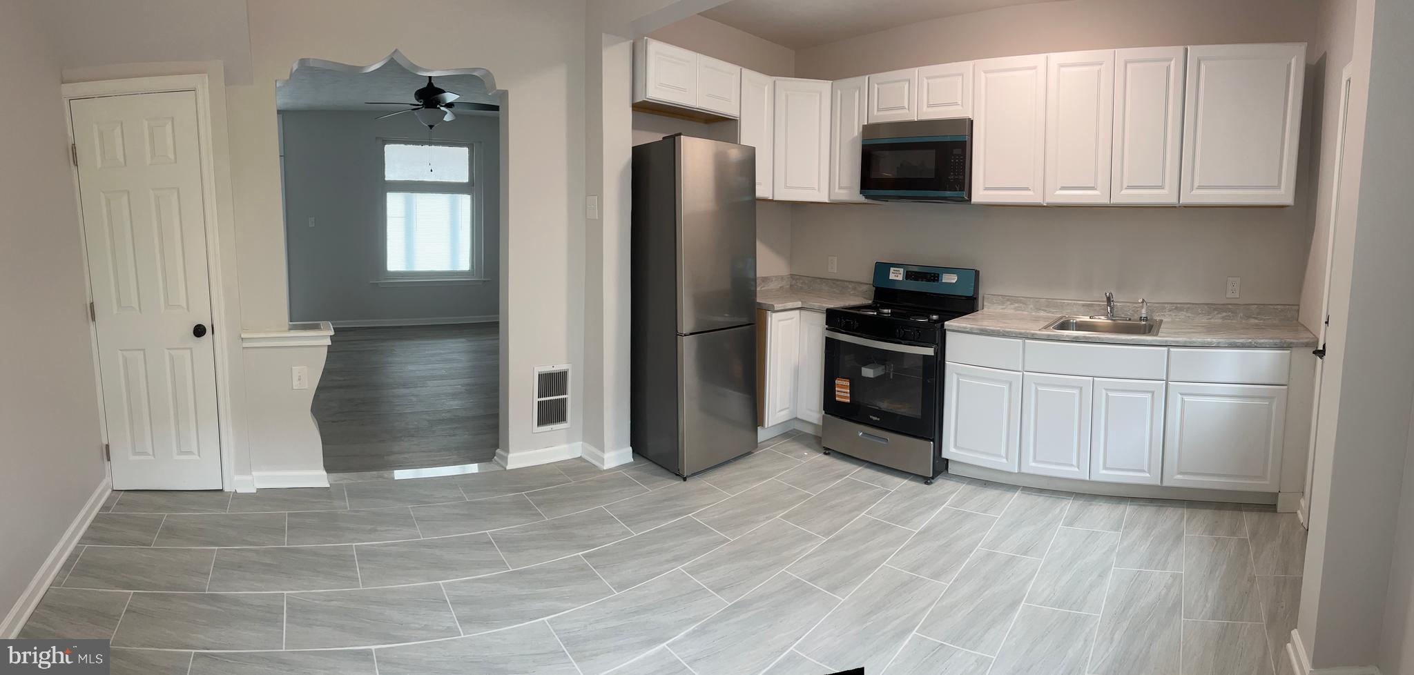 5519 Race Street Philadelphia, PA 19139 - Photo 10 of 25 a kitchen with stainless steel appliances granite countertop a stove a refrigerator and a sink