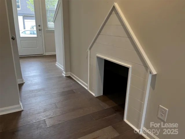 a view of a hallway to rooms and stairs
