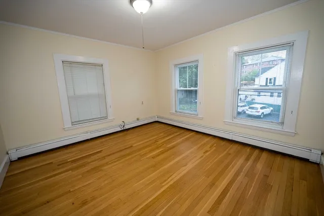wooden floor in an empty room with a window