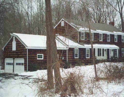 22 Seir Hill Road Wilton, CT 06897 - Photo 1 of 1 a front view of a house with a yard covered in snow