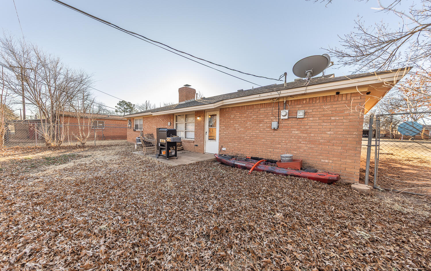 2408 33rd Street Lubbock, TX 79411 - Photo 14 of 31 a backyard of a house with table and chairs