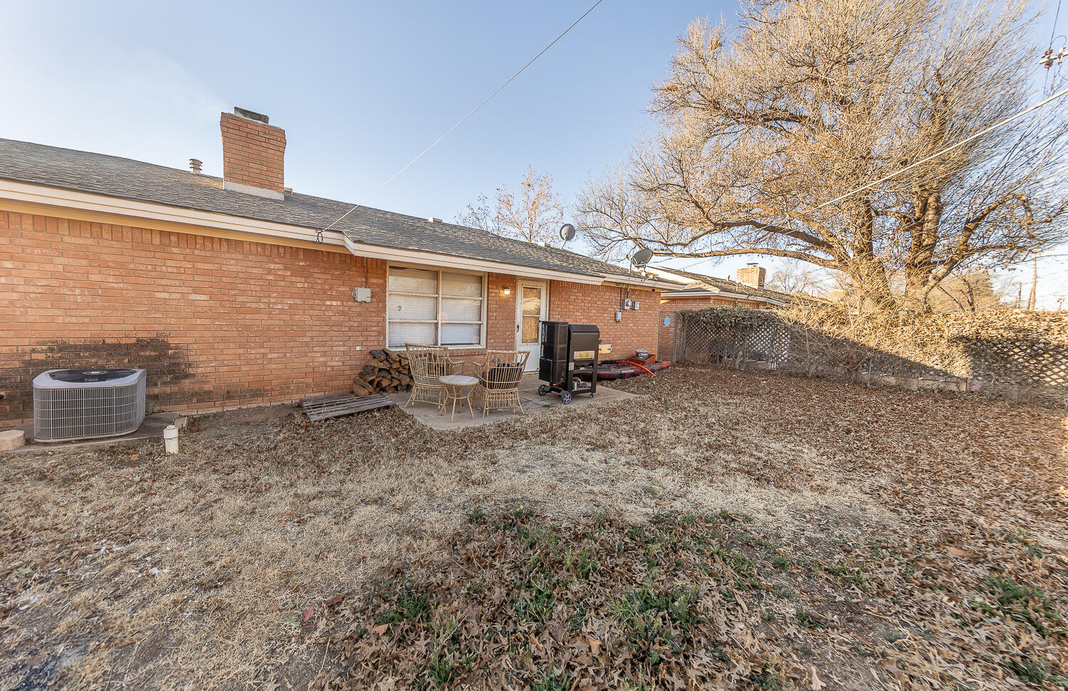 2408 33rd Street Lubbock, TX 79411 - Photo 15 of 31 a backyard of a house with multiple trees