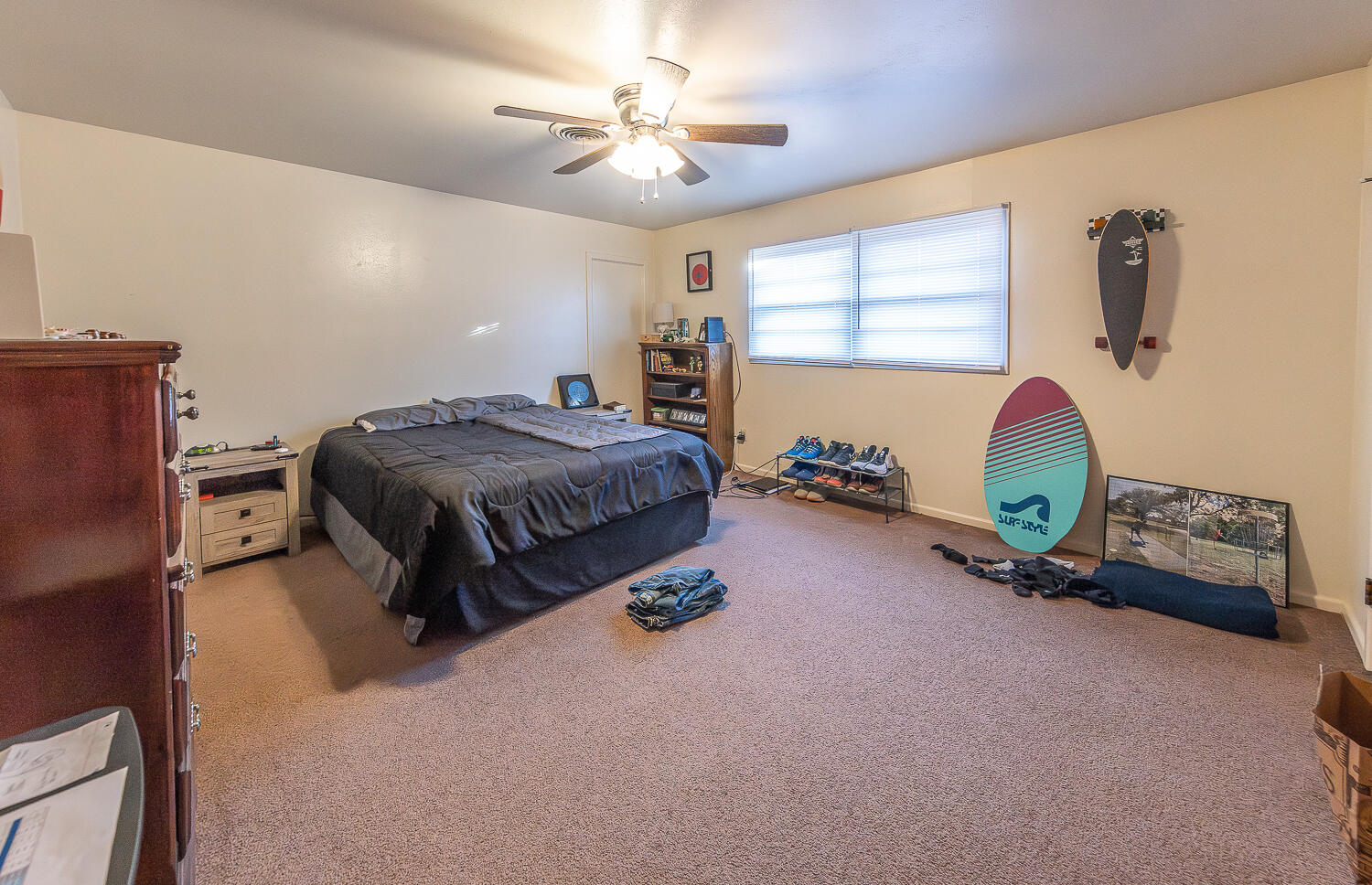 2408 33rd Street Lubbock, TX 79411 - Photo 17 of 31 a bedroom with a bed and a chandelier
