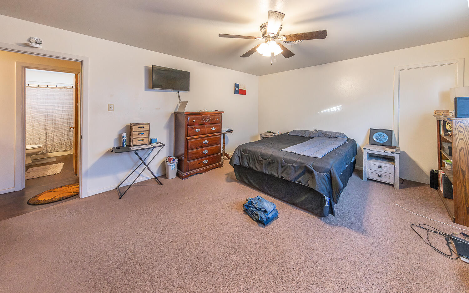 2408 33rd Street Lubbock, TX 79411 - Photo 18 of 31 a living room with a bed furniture and a flat tv screen