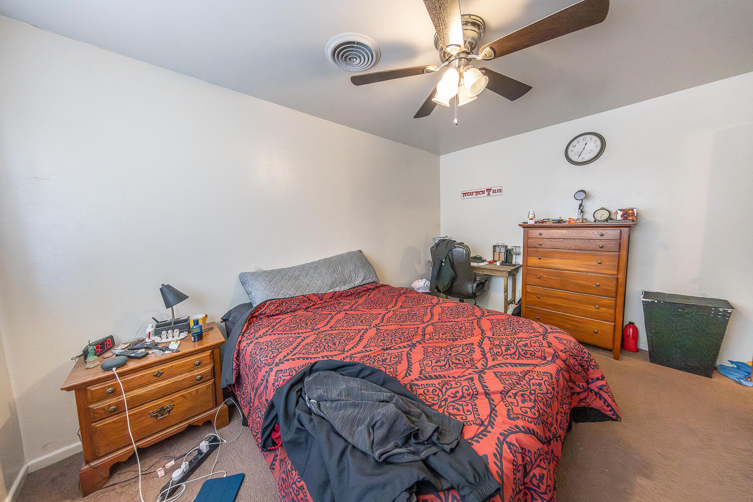 2408 33rd Street Lubbock, TX 79411 - Photo 20 of 31 a bedroom with a bed and a chandelier