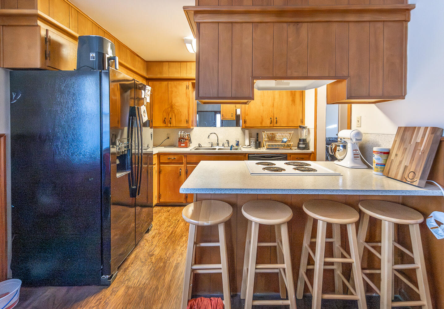 2408 33rd Street Lubbock, TX 79411 - Photo 23 of 31 a kitchen with a sink and a refrigerator