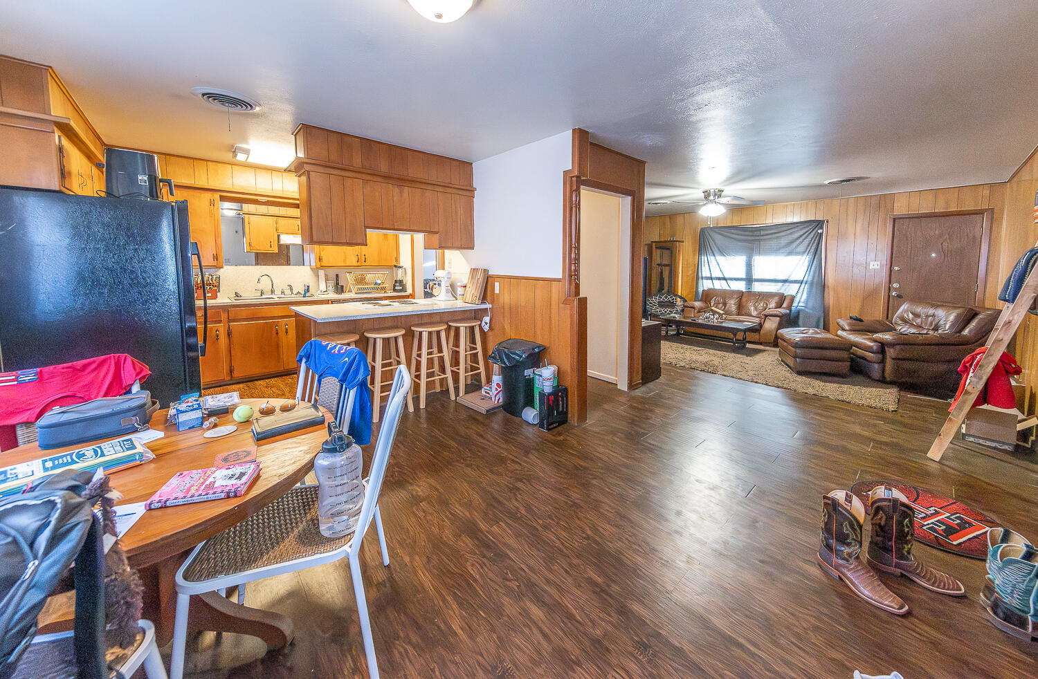 2408 33rd Street Lubbock, TX 79411 - Photo 25 of 31 a dining room with furniture wooden floor and a kitchen view